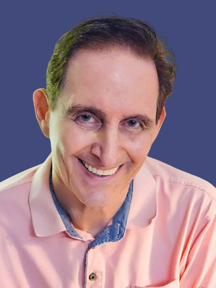 A man with a pink shirt and blue shirt smiling.