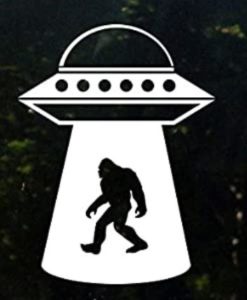 A picture of an alien and bigfoot in the background.